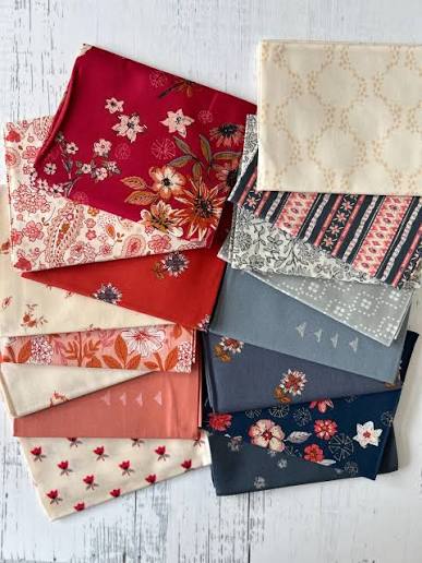 Fat quarter fabric bundle: red, cream, blue floral and geometric prints in stacked pieces