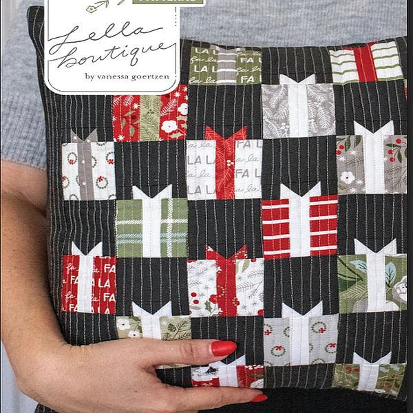 Quilted patchwork Christmas pillow cover with dark striped squares, red green and white appliques