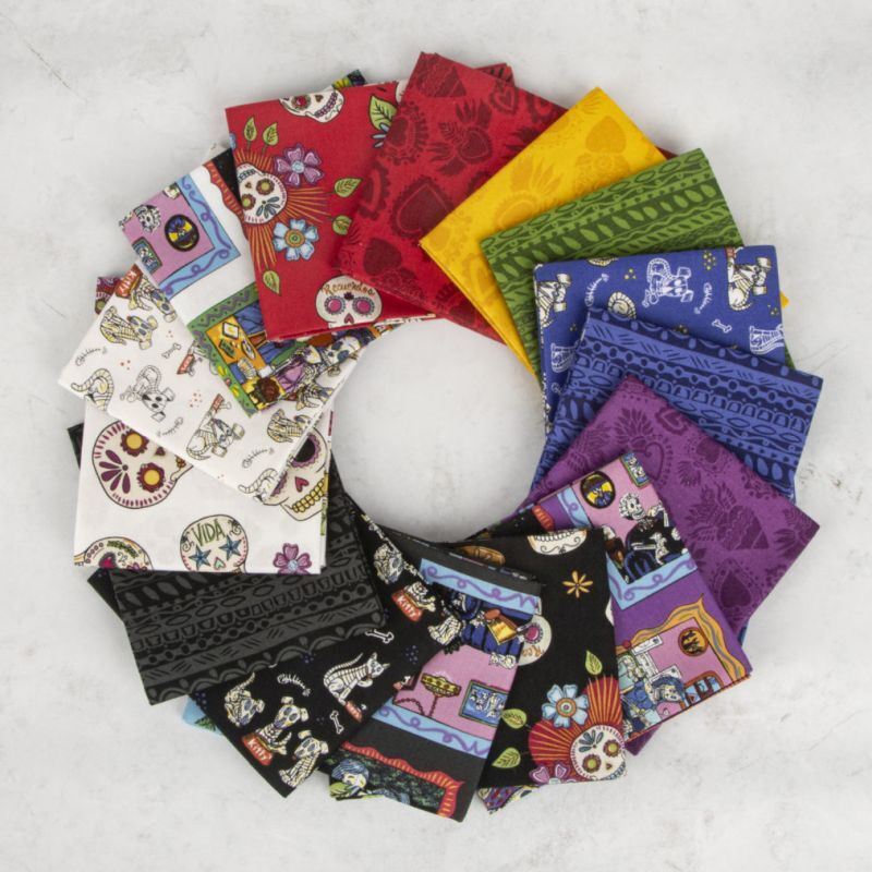 Assorted sugar skull print fat quarters, red, yellow, purple, blue, and black fabrics