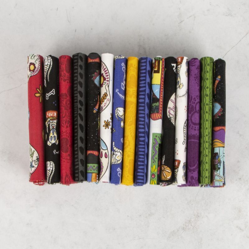 Printed fabric fat quarters in rows, mixed skull motifs on dark and bright colors