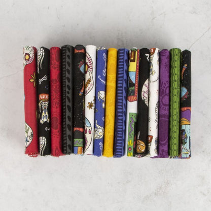 Printed fabric fat quarters in rows, mixed skull motifs on dark and bright colors