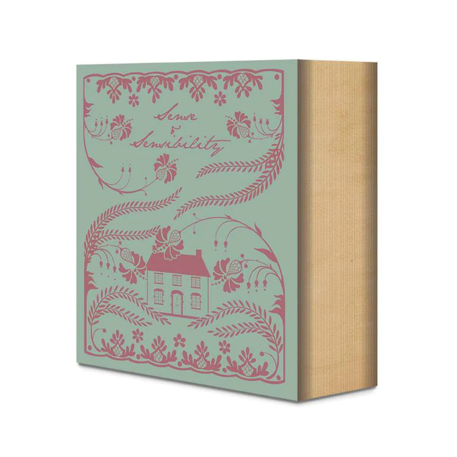 Quilt kit packaging box with teal background and pink house illustration, tan side panel