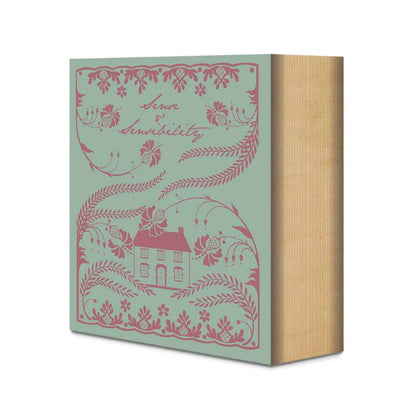 Quilt kit packaging box with teal background and pink house illustration, tan side panel