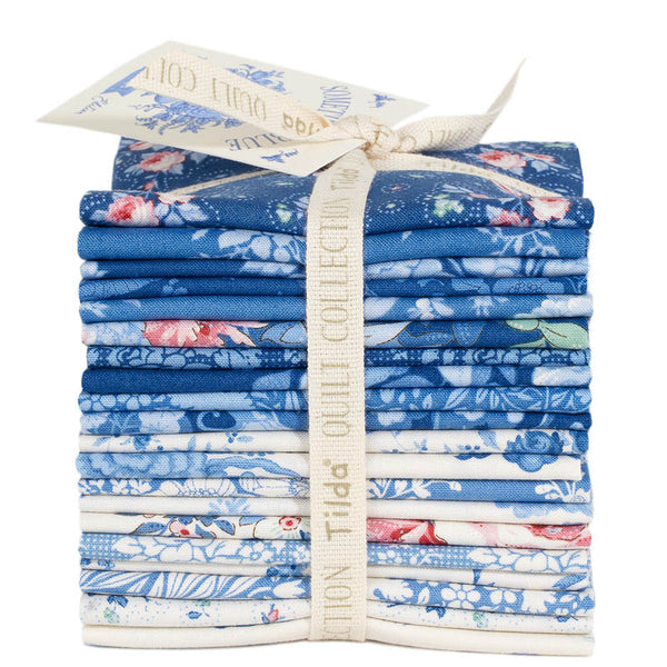 Blue floral fabric fat eighth bundle, stacked and tied with cream ribbon