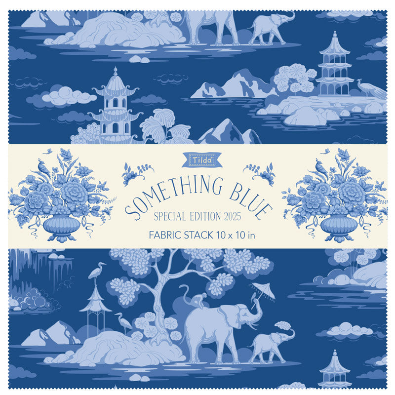 Blue and white fabric squares stack with illustrated elephants, clouds, and towers