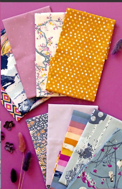 Folded cotton fat quarters bundle with floral, polka dots, stripes, and animal prints