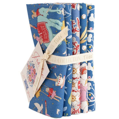 Blue fabric fat quarter bundle with holiday animal motifs, wrapped with ribbon