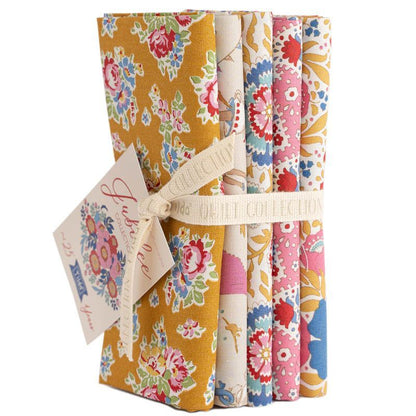 Floral fat quarter bundle with tied ribbon, mustard yellow and multicolor patterned fabrics
