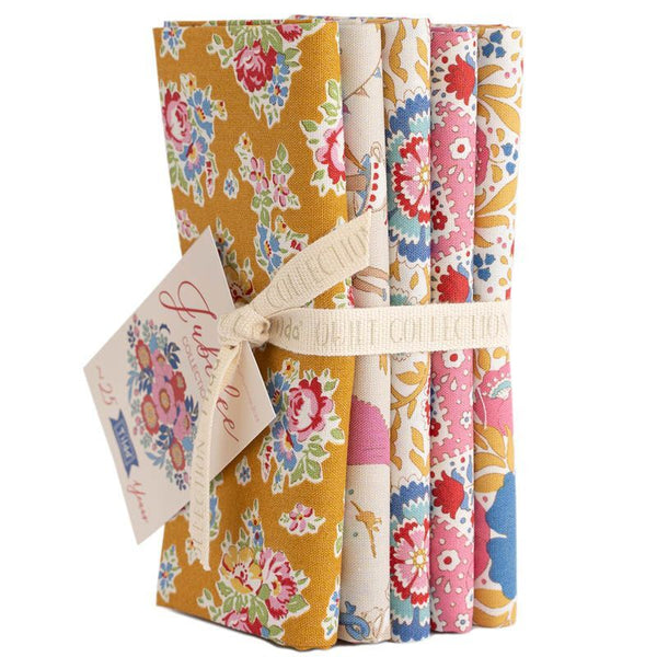 Floral fat quarter bundle with tied ribbon, mustard yellow and multicolor patterned fabrics