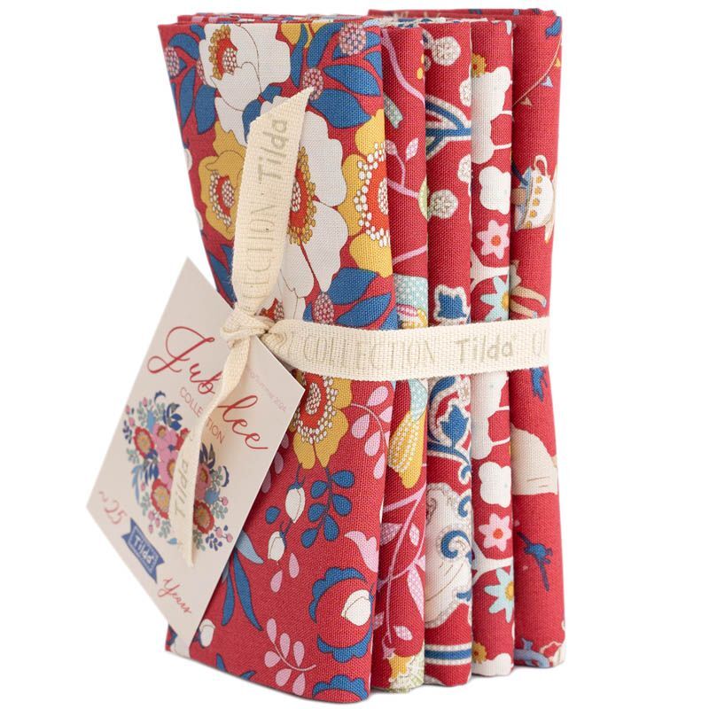 Cotton fat quarter bundle with red, cream, and blue floral patterns, tied with ribbon