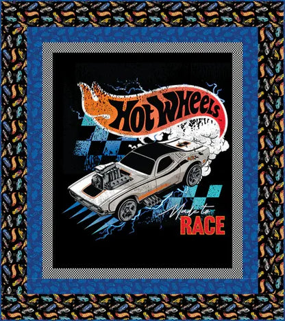 Hot Wheels racing car quilt block with black background, blue frame border, and checker accents