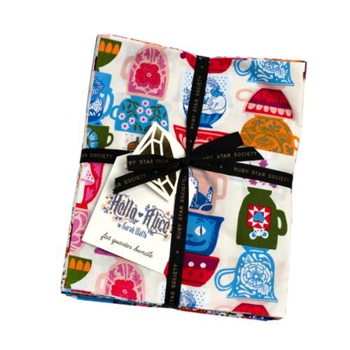 Fabric fat quarter bundle with multicolor whimsical prints, neatly tied in a stack