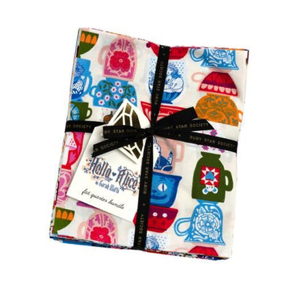 Fabric fat quarter bundle with multicolor whimsical prints, neatly tied in a stack