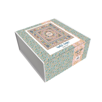 Quilt kit box with blue, pink, and cream patchwork fabric design on the lid.