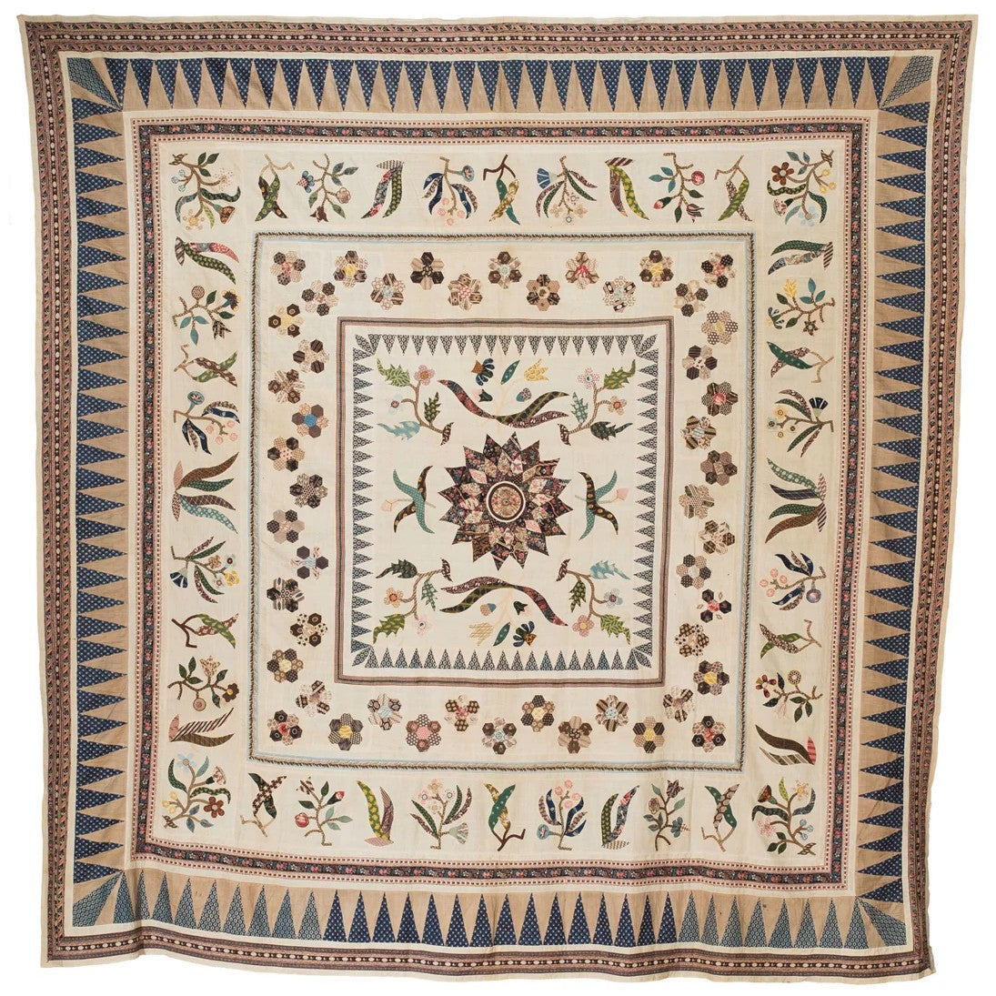Quilt coverlet with ornate floral and border medallion pattern in blue and tan