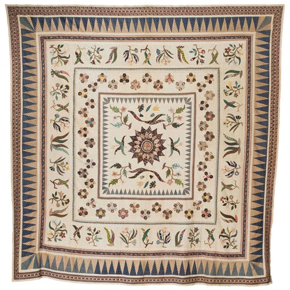 Quilt coverlet with ornate floral and border medallion pattern in blue and tan
