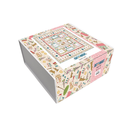 Folded boxed quilt kit with colorful patchwork top and multicolor stripe border