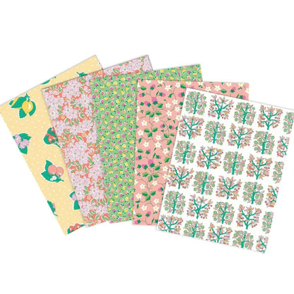 Five square fabrics fanned out on a white background, each with a different floral and botanical print in pastel tones including yellow, pink, green, and white.