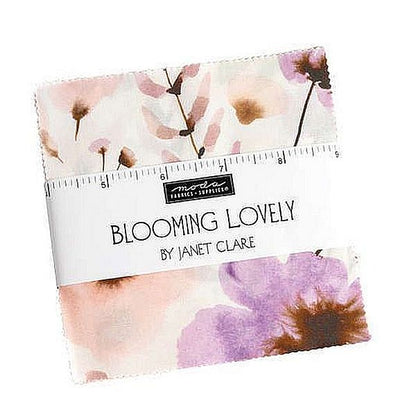 Charm pack of 5-inch fabric squares with watercolor florals in pink, purple, cream
