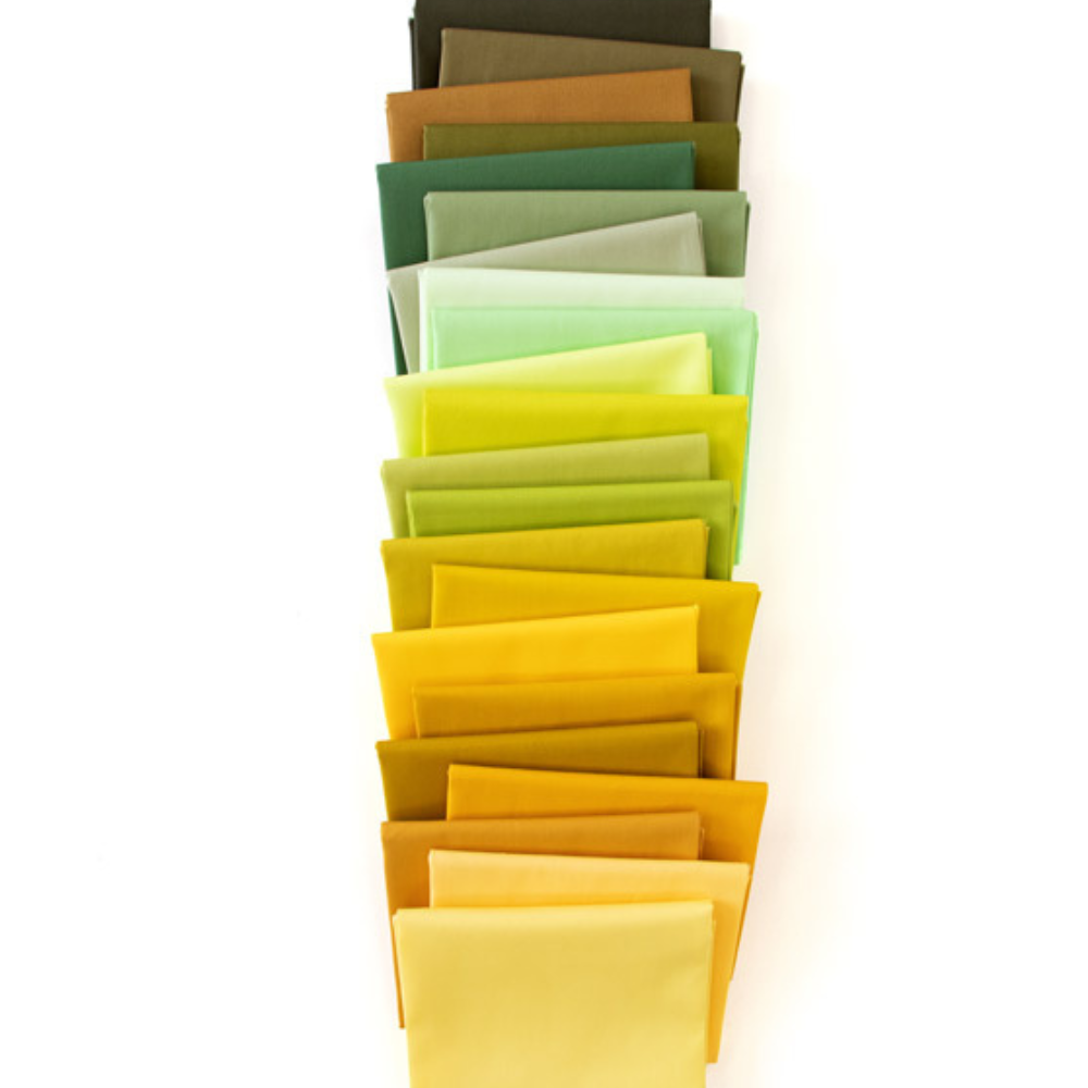Fabric fat quarter bundle of solid squares in greens, yellows, and golds