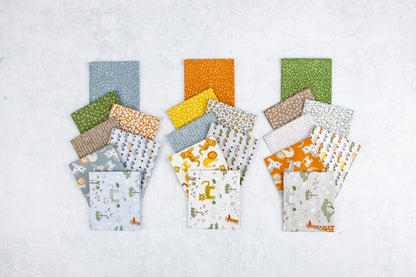 Assorted Leo and Savannah fabric strips showing lions, elephants, giraffes and coordinating nature designs