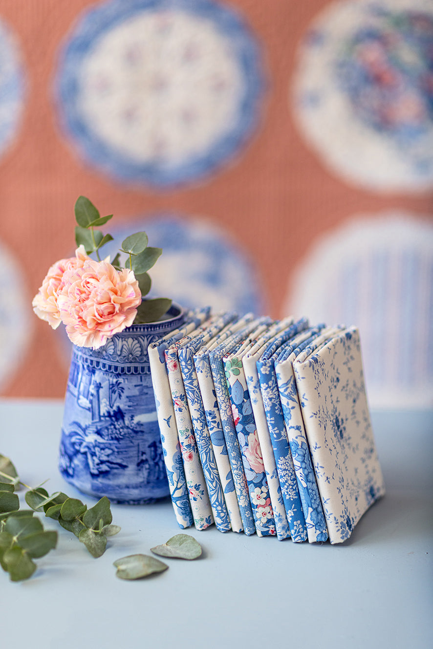 Fat quarter fabric bundle with blue, pink, and white floral prints in a wrap