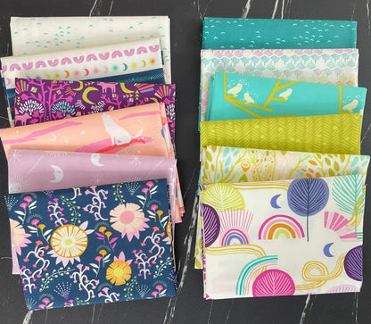 Fat quarter fabric bundle with mixed prints in teal, purple, pink, and peach colors