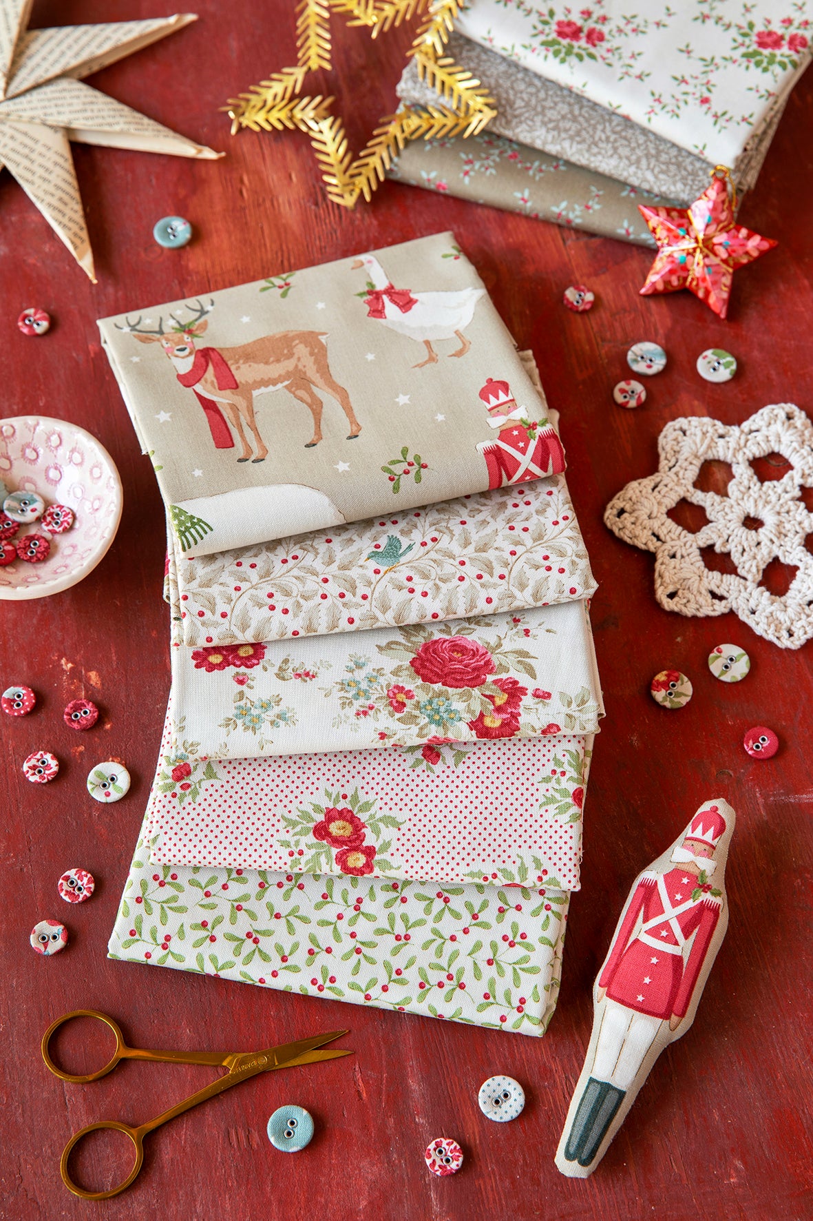 Beige Christmas fat quarters, five folded pieces with deer, florals, dots, and sprigs