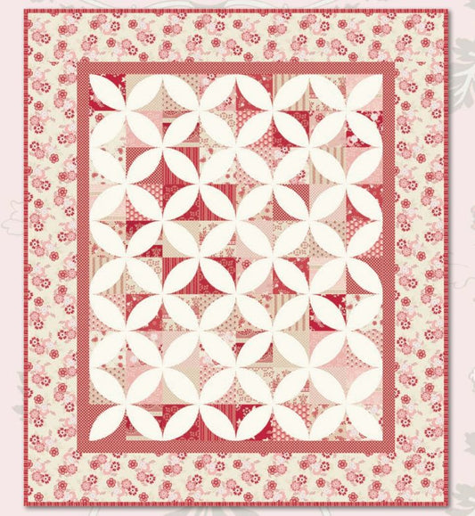 Square quilt pattern layout with red floral border and cream geometric blocks