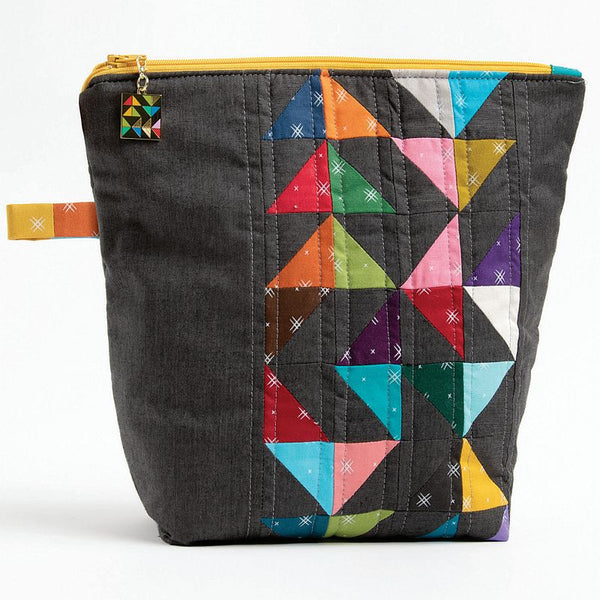 Quilted mini zipper pouch with multicolor patchwork front, black fabric, yellow zipper