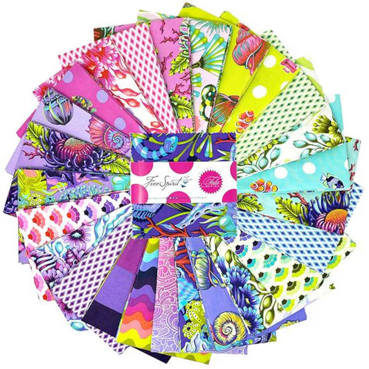 Tula Pink Collection of colorful fabric swatches with fish, shells, florals, arranged in a circular pattern with a brand label in the center.
