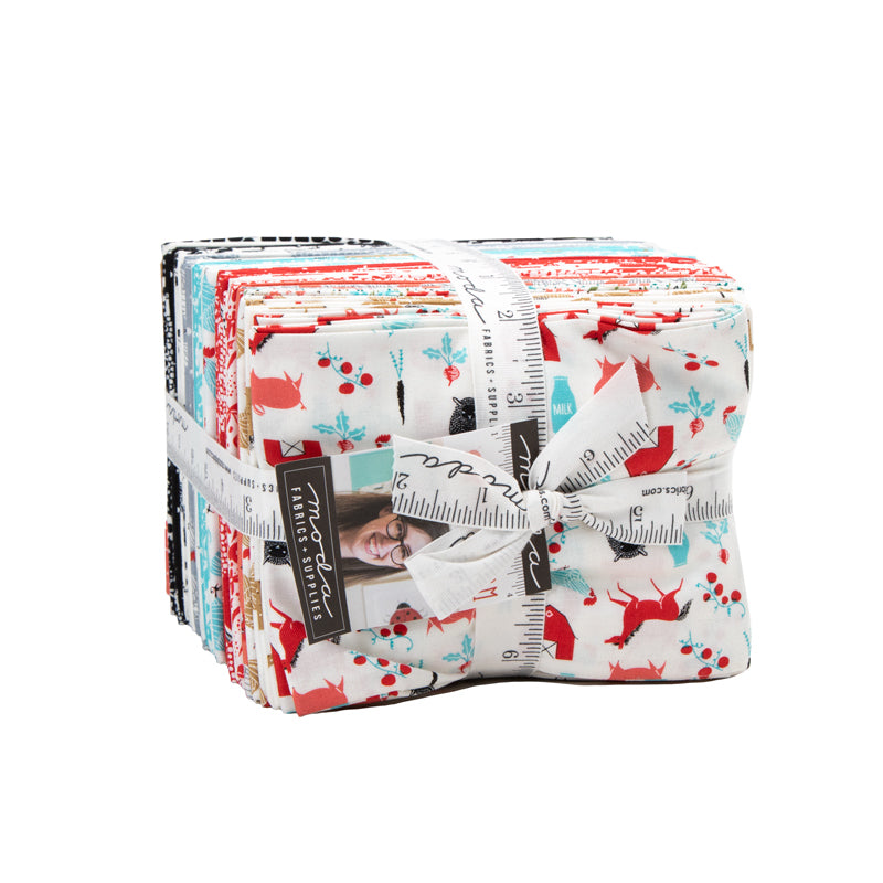 Stack of fabric bundles tied with a ribbon on a white background