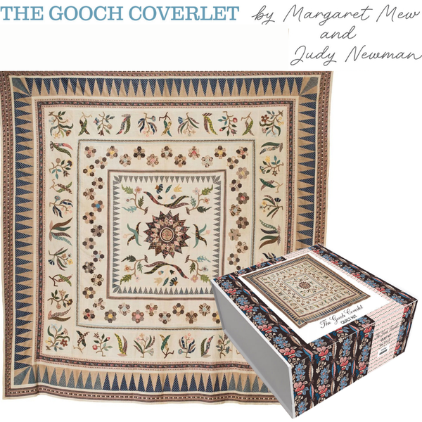 Quilt coverlet featuring central sunburst medallion with birds and floral vine motifs