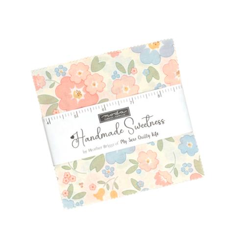 5-inch charm pack of pastel floral patchwork fabric squares, neatly wrapped