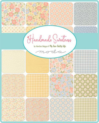 Charm pack fabric squares in pastel florals and checks arranged in a grid