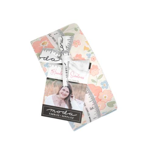 Floral quilt fabric jelly roll bundle in pastel tones with patterned strips, Moda label.