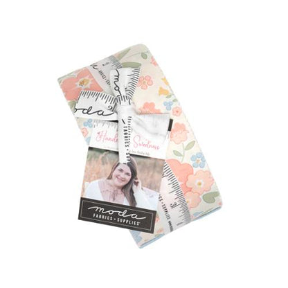 Floral quilt fabric jelly roll bundle in pastel tones with patterned strips, Moda label.