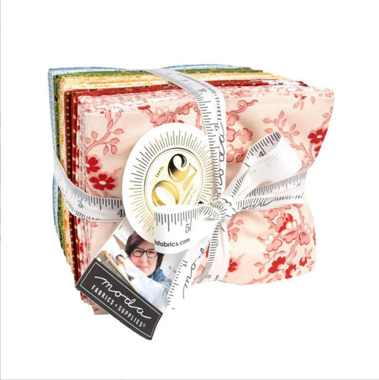 Fat quarter fabric bundle with floral prints in red, pink, cream, and green layers