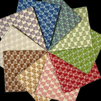 Floral fabric fat quarter assortment with dark blue, green, cream, red, and brown prints