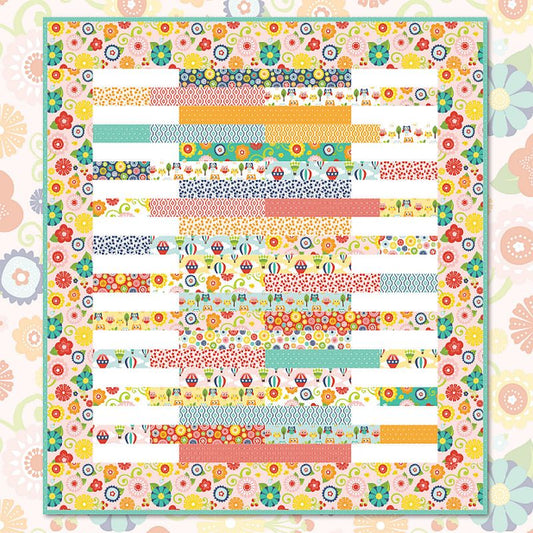 Colorful patchwork quilt top with striped blocks and floral fabric motifs, finished layout