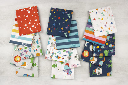 Collection of colorful fabric swatches with various patterns on a light gray surface.