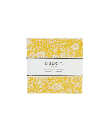 A charm square pack of Liberty Fabrics cotton piecing fabrics with a yellow and white floral pattern, wrapped in a white paper band labeled 'LIBERTY FABRICS'.