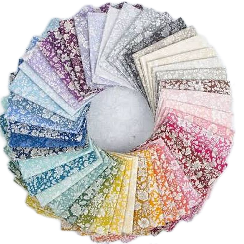 A circular arrangement of many fabric swatches in different colors and floral patterns, displayed on a white background.