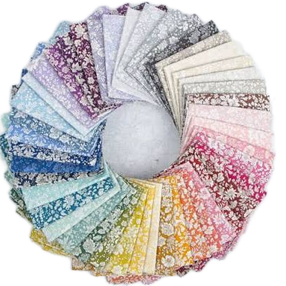 A circular arrangement of many fabric swatches in different colors and floral patterns, displayed on a white background.