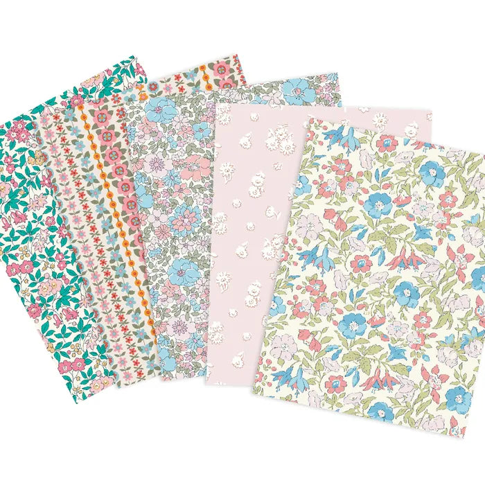 A set of five patterned fabrics fanned out on a white background, featuring various floral and geometric designs in pastel colors including pink, blue, green, and orange.