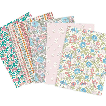 A set of five patterned fabrics fanned out on a white background, featuring various floral and geometric designs in pastel colors including pink, blue, green, and orange.