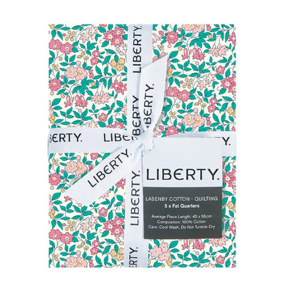 Fabric bundle with Liberty Fabric Lasenby Cotton ribbon and lable showcasing pretty florals