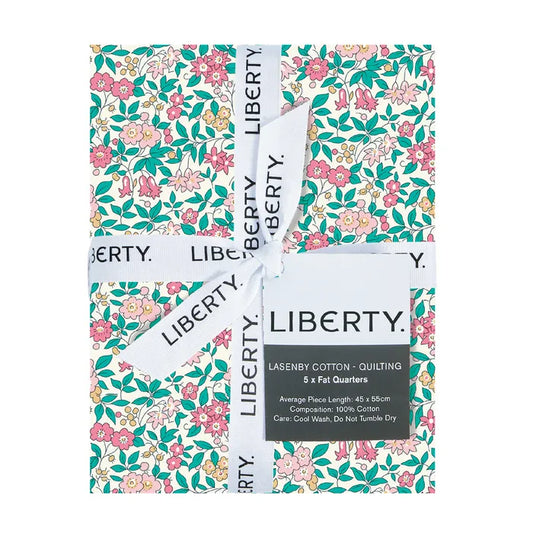 Fabric bundle with Liberty Fabric Lasenby Cotton ribbon and lable showcasing pretty florals