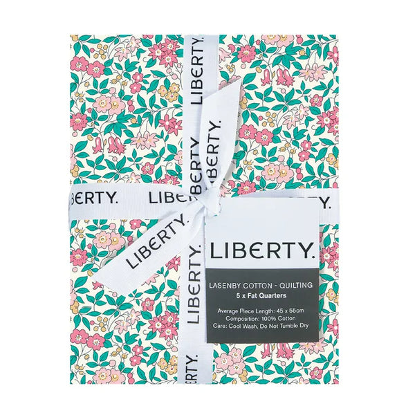Fabric bundle with Liberty Fabric Lasenby Cotton ribbon and lable showcasing pretty florals