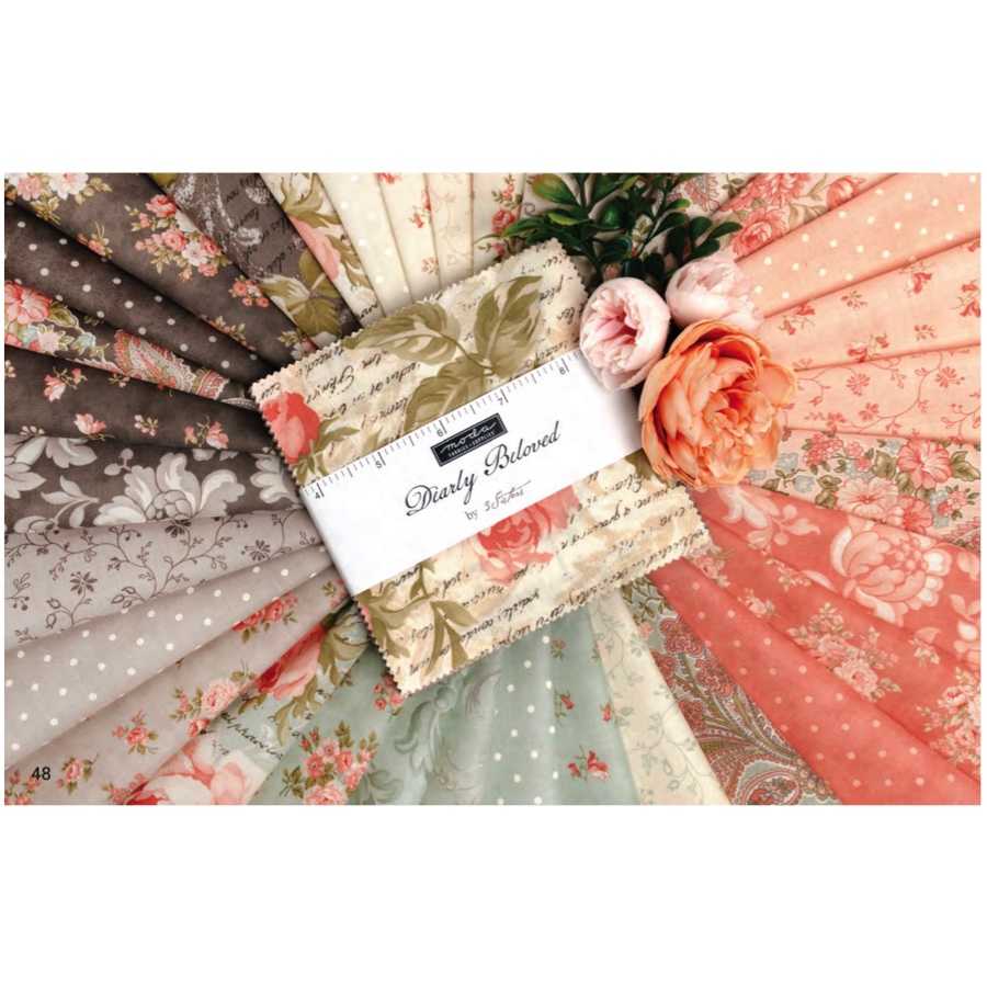 Floral quilt fabric bundle with stitched tag; peach, pink, gray prints in fabric squares